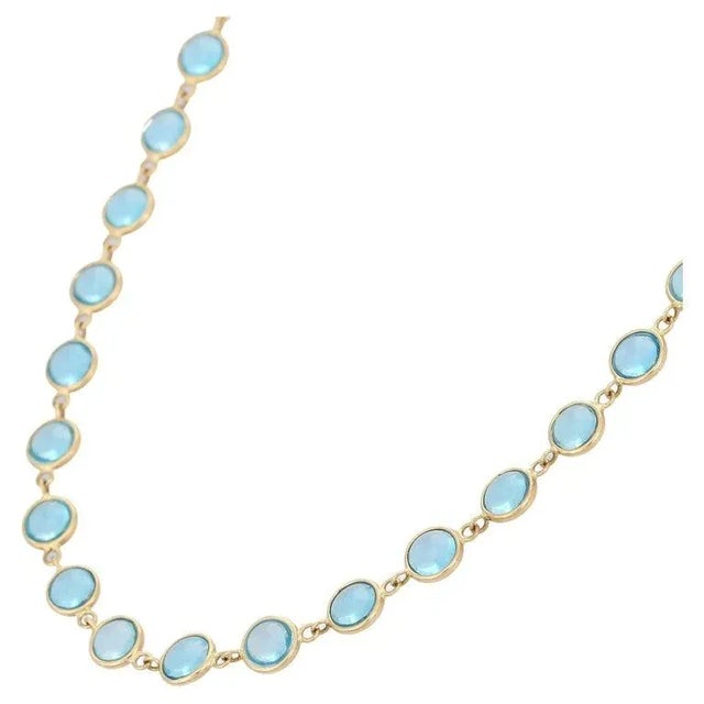 This is part of Chairish’s Fine Jewelry assortment. Blue Topaz Necklace in 18K Gold studded with round cut topaz pieces....