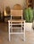 Coastal contemporary counter stool crafted with a crisp white wood frame and natural rattan seat and back for a light,...