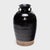 Cloaked inside and out with a glossy black glaze, this antique Chinese pickling pot was originally used for fermenting...