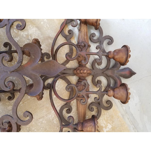 French fluer de Los themed iron and wood wall sconces with four candle Holders each.