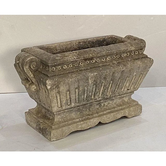 A fine large rectangular English garden trough or planter of composition stone, in the Classical style, featuring a raised...