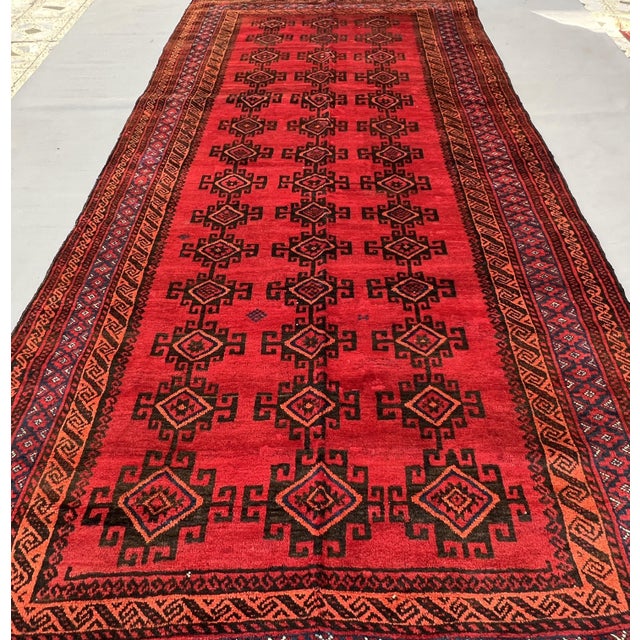 A commanding antique Ersari Beshir Turkmen tribal gallery rug — three columns of bold angular C-scroll motifs flank hooked...