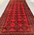 A commanding antique Ersari Beshir Turkmen tribal gallery rug — three columns of bold angular C-scroll motifs flank hooked...
