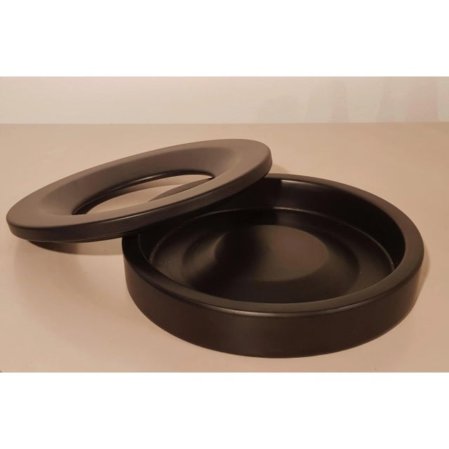 Reduced-nonsense design for a (ashes) shell. consisting of two parts, the piece can be easily cleaned. Matt black glaze....