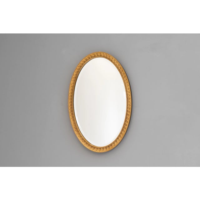 Oval mirror with gilded frame and original bevelled plate. U.K circa 1930.