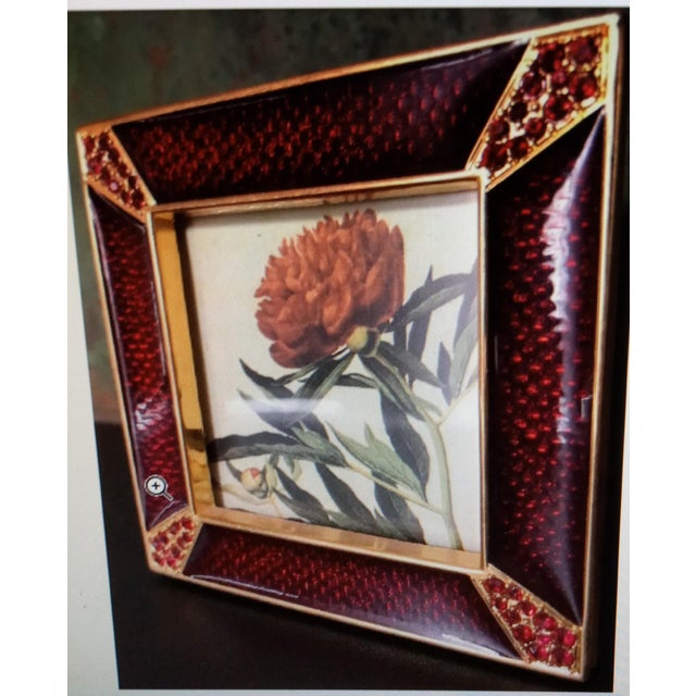 Exquisite Jay Strongwater square picture frame features a deep, jewel-toned red enamel with a subtle, textured pattern...