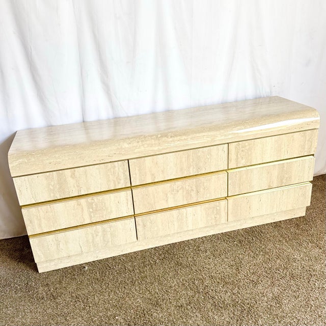 A striking postmodern dresser showcasing the sculptural appeal of faux travertine laminate in a clean waterfall...