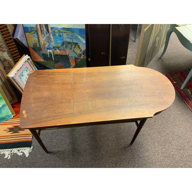 Unusual Mid Century walnut table with rotary drawer and brass rod lower shelf.Table is solid and sturdy but in need...