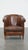 Special, characteristic and stately dark sheep leather club chair with a finish with black piping. This great sheep...
