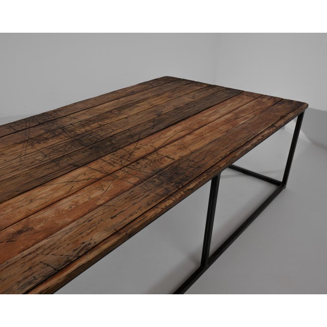 Wooden planks from France, circa 1950, rest on a steel base. Blending sleek and rustic, this 18” tall coffee table makes a...