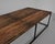 Wooden planks from France, circa 1950, rest on a steel base. Blending sleek and rustic, this 18” tall coffee table makes a...