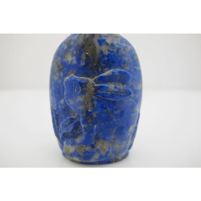 Antique Chinese snuff bottle in deep blue Lapis Lazuli showcasing characteristic white calcite matrix streaks and...