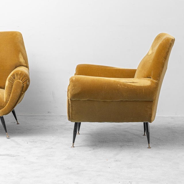 Pair of armchairs made in the 1950s. Upholstered in mustard-colored velvet. Good condition. Shows signs of wear, as shown...