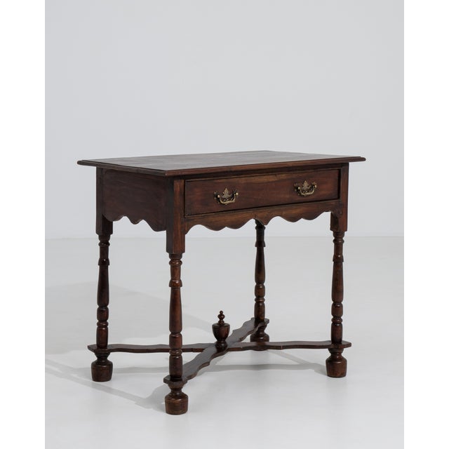 A distinguished example of the William and Mary style, this English side table speaks to the refined cabinetmaking...