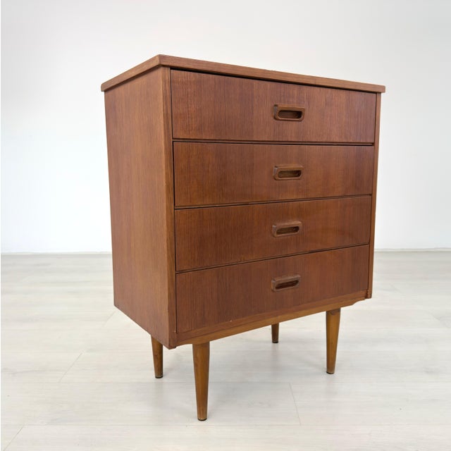 Dimensions: H 29.7” x W 24.3” x D 13.3” Mid-Century Modern chest of drawers with 4 drawers with recessed handles,...