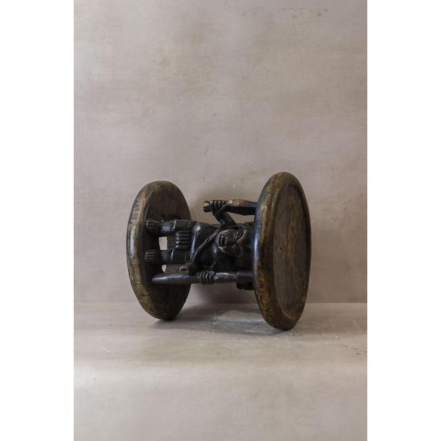 This Baule wood carved vintage stool is a stunning piece of traditional African craftsmanship. Hand-carved from solid wood...