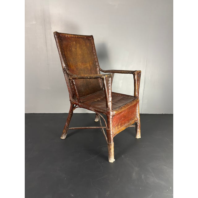 Extremely rare example of an oil cloth upholstery technique applied to an an original Art Deco rattan colonial armchair (...