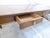 This solid walnut dining table has an inlay design in the center, three drawers and pullout slides in either end.