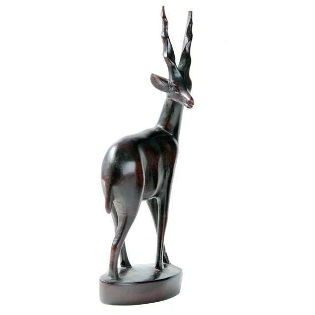 Add a beautiful touch to your decor with this gracefiul hand-carved gazelle sculpture made from an exotic polished dark...