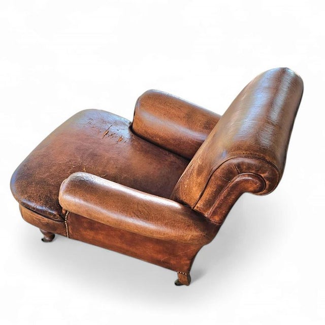 Beautiful and stately old English sheep leather club chair with armrests. This type of chair is often found in an English...