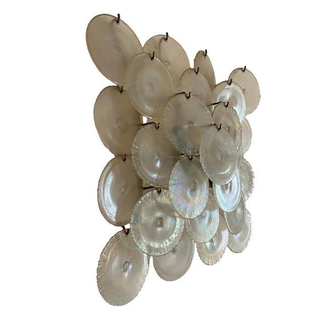 Large disc-shaped applique in irridescent Murano glass from Mazzega Murano, Italy 1960. The applique rests on a nickel-...
