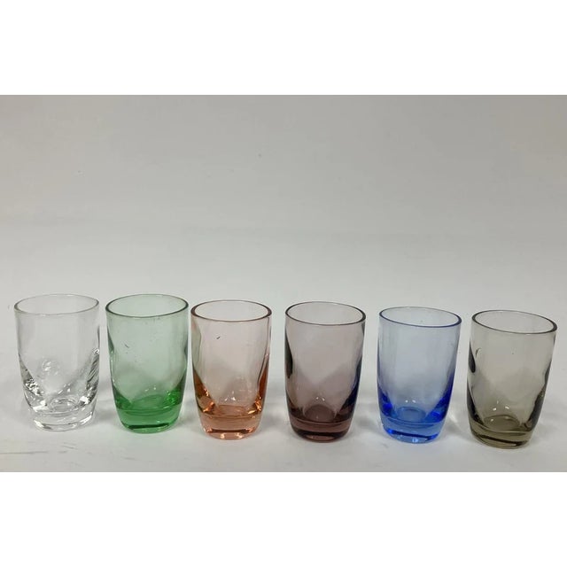 **DESCRIPTION** A charming vintage Japanese cordial set, circa 1950s–1960s, comprising six petite glasses in assorted...