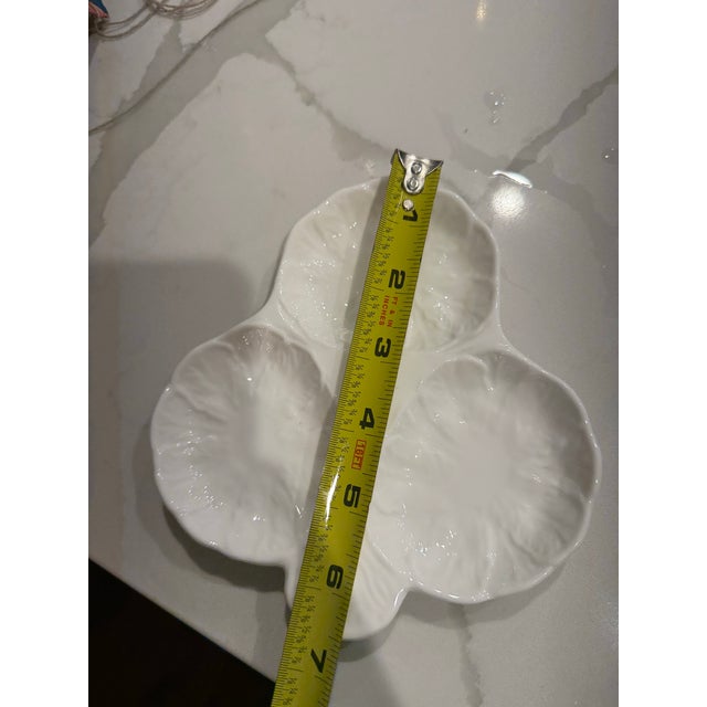 This is a Wedgewood china piece with three sections. Made to look like cabbage leaves, it could be used to serve oysters...