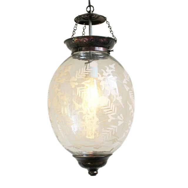 Elegant vintage pendant light from India featuring a gracefully rounded clear glass globe beautifully etched with delicate...