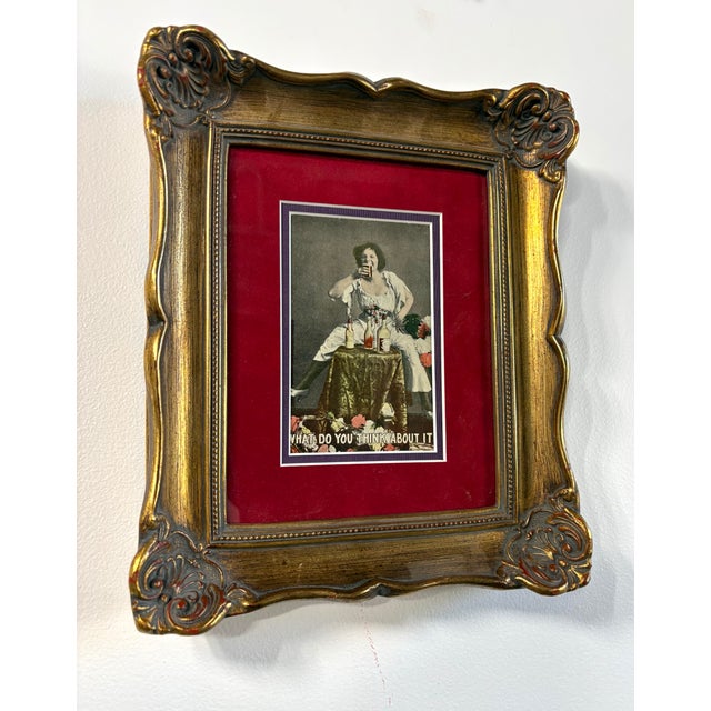 This is a fun, cheeky slice of early 20th-century humor. It’s an original hand-tinted postcard featuring a woman in a...