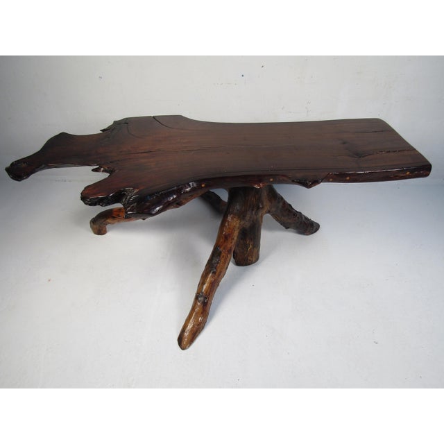 Impressive rustic slab table. Amply sized tabletop, with a sprawling root base. Interesting table sure to make a nice...