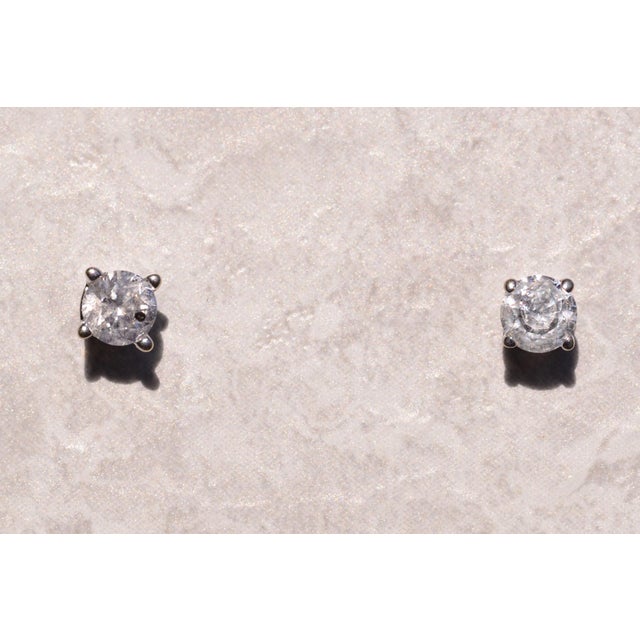 The 146th Street: White Gold Natural Diamond Studs. The earrings feature four prong set round brilliant cut natural...