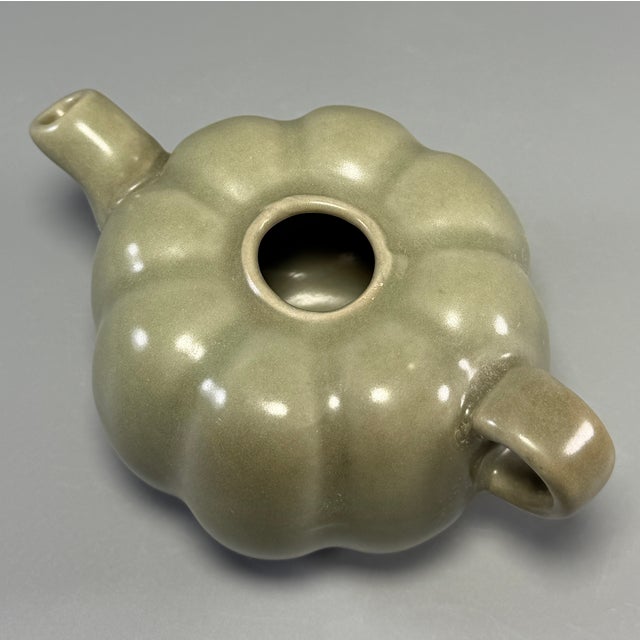 Fine antique Chinese celadon melon‑shaped ewer. Charming lobed melon form, fitted with curved handle and short spout,...