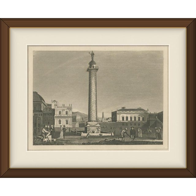 This antique engraving of Trajan's Pillar shows Trajan's Column standing in its square in Rome with a domed church and an...