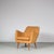 A stunning lounge chair in the style of Finn Juhl, manufactured in Denmark around 1950. The chair is upholstered in high...