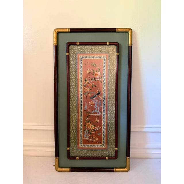 Elegant mid-century Asian silk embroidery featuring a songbird perched among blooming branches and fluttering butterflies....
