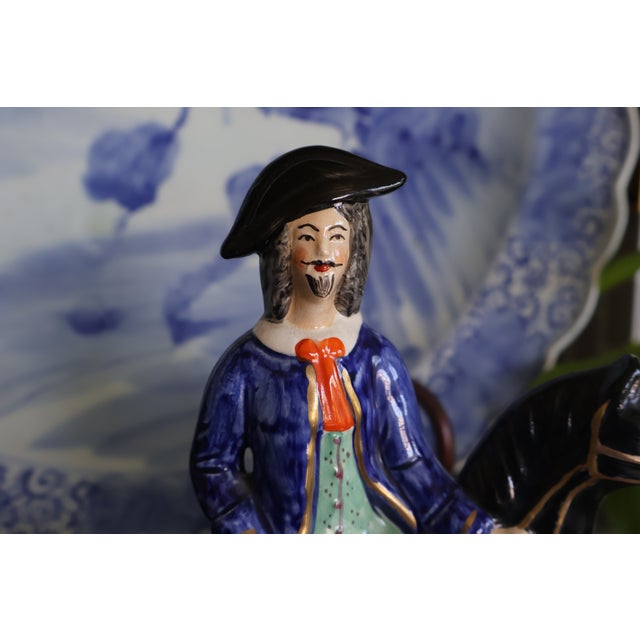 A colorful matched pair of vintage ceramic equestrian figures depicting the legendary English highwaymen Dick Turpin and...
