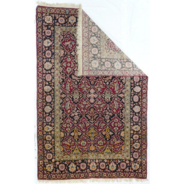 Not in the usual medallion style, but an allover cartouche lattice pattern in red and navy, of upright flowers and...