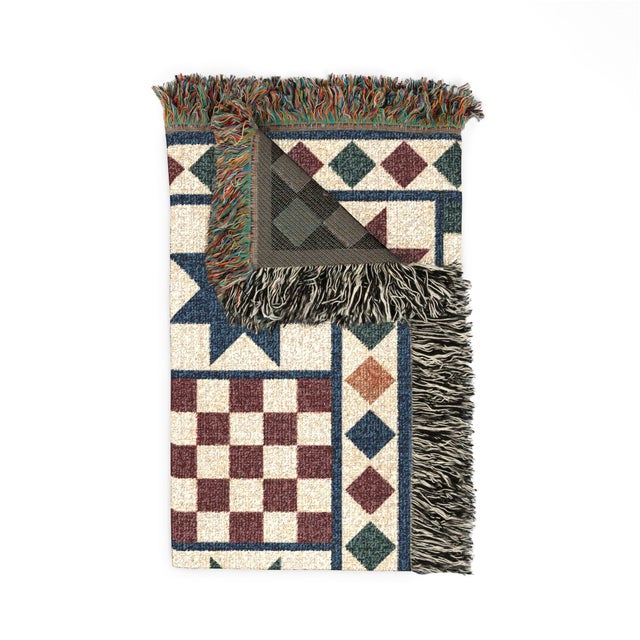 This folk art star woven throw blanket features alternating star and checkerboard blocks in navy blue, forest green,...
