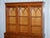 A beautiful Vintage English Burr Yew Wood 3 Door Glazed Display Bookcase Cabinet, combining classic form with richly...