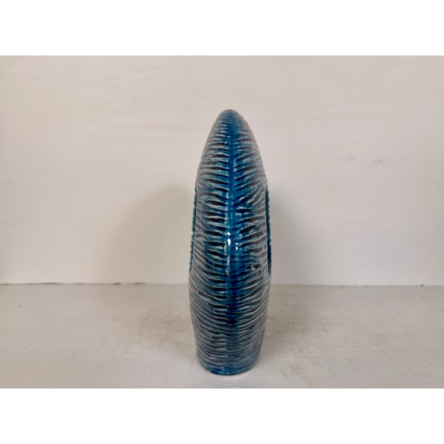 With an unstated ridged texture and a vibrant blue glaze this ceramic fish would make a wonderful accent piece for any...