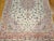 "This elegant Persian Tabriz rug features a finely woven floral pattern set against a soft ivory (cream) background,...