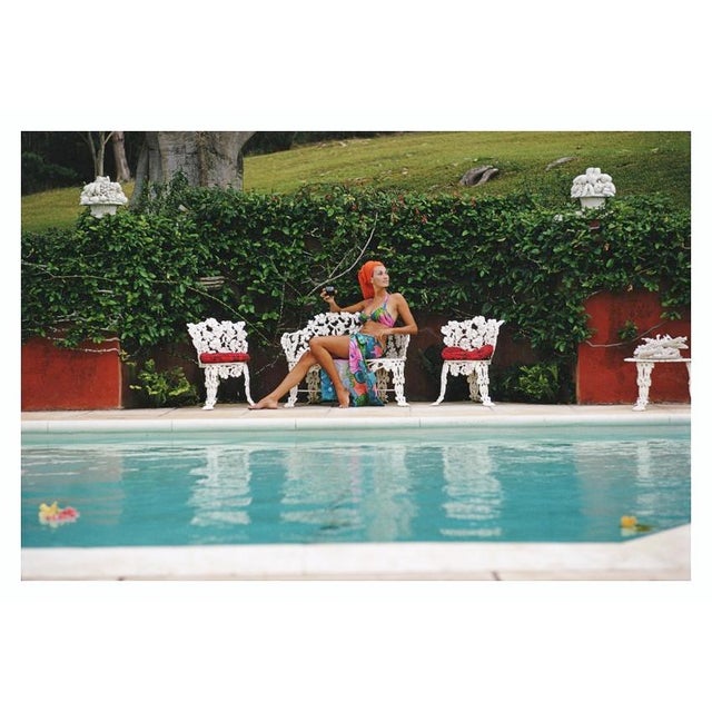 Lounging In Bermuda 1969 A woman relaxes with a drink by a swimming pool in Bermuda, November 1969. Slim Aarons Slim...