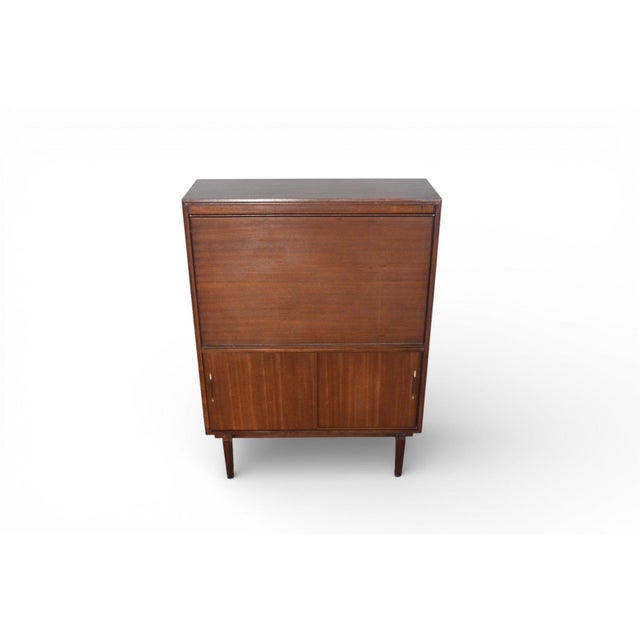 This narrow mahogany cocktail bar by Beaver & Tapley is designed to offer maximum function within a compact footprint....