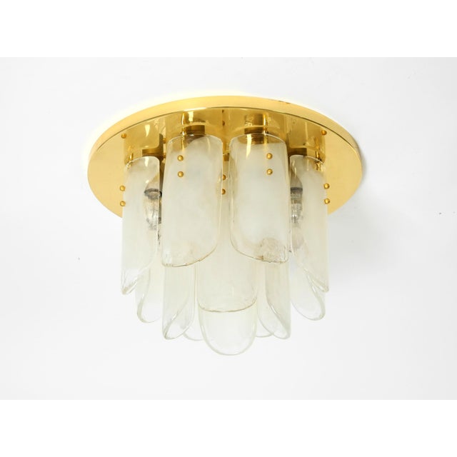 Rare heavy murano glass flower pendant light with brass base. brass base with 12 long murano glass shades in white and...