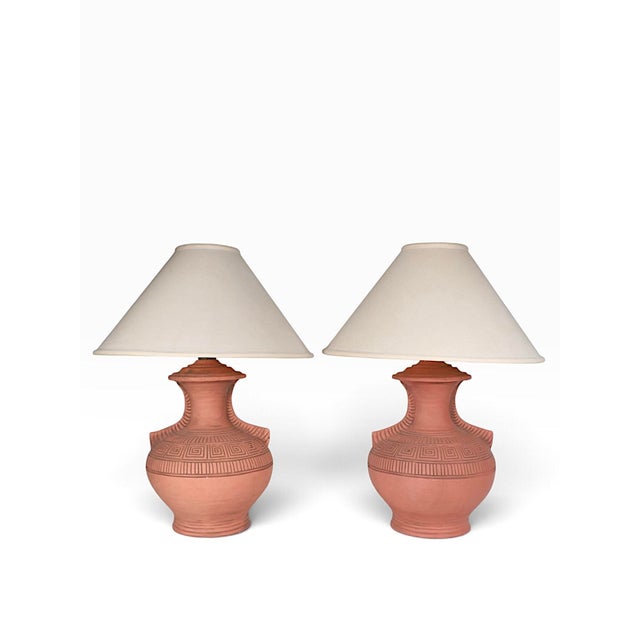 Stylish pair of Terra Cotta pottery vase form table lamps, in excellent, original, clean, and working condition. The lamps...