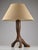 Striking French table lamp from the 1950s, crafted in solid olive wood and embodying a sculptural Brutalist aesthetic. The...
