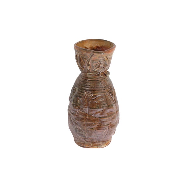 A studio pottery vase by American artist Barry Unitas Barnes. The vase is characterized by an elongated organic shape with...