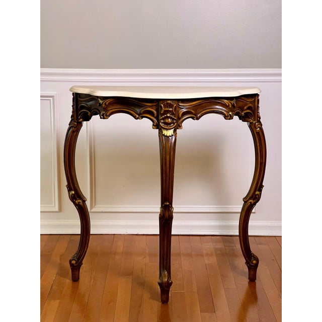 French demi-lune form carved walnut narrow console table with a white marble top and gilt detail in Louis XV rococo style,...