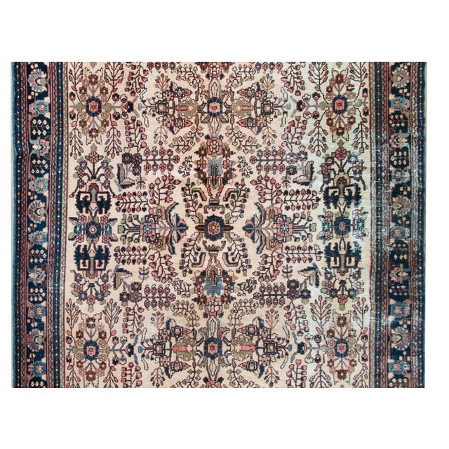 A stunning early 20th century Persian Dargazin rug with a beautiful mirrored floral and tree-of-life pattern woven in...