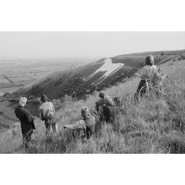 Westbury White Horse A group of people viewing the Westbury White Horse, an ancient hill figure on the escarpment of...